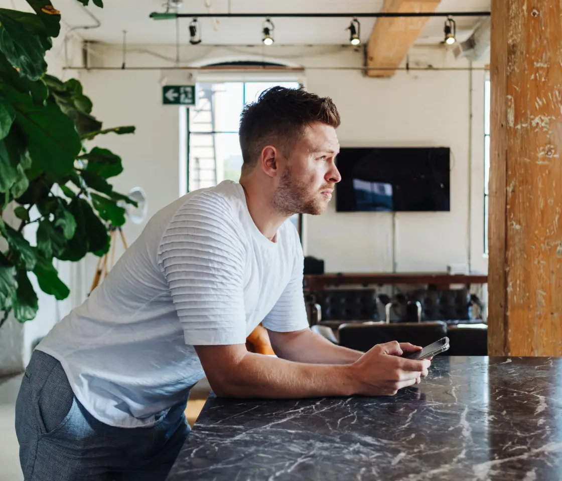 A guy on his phone thinking