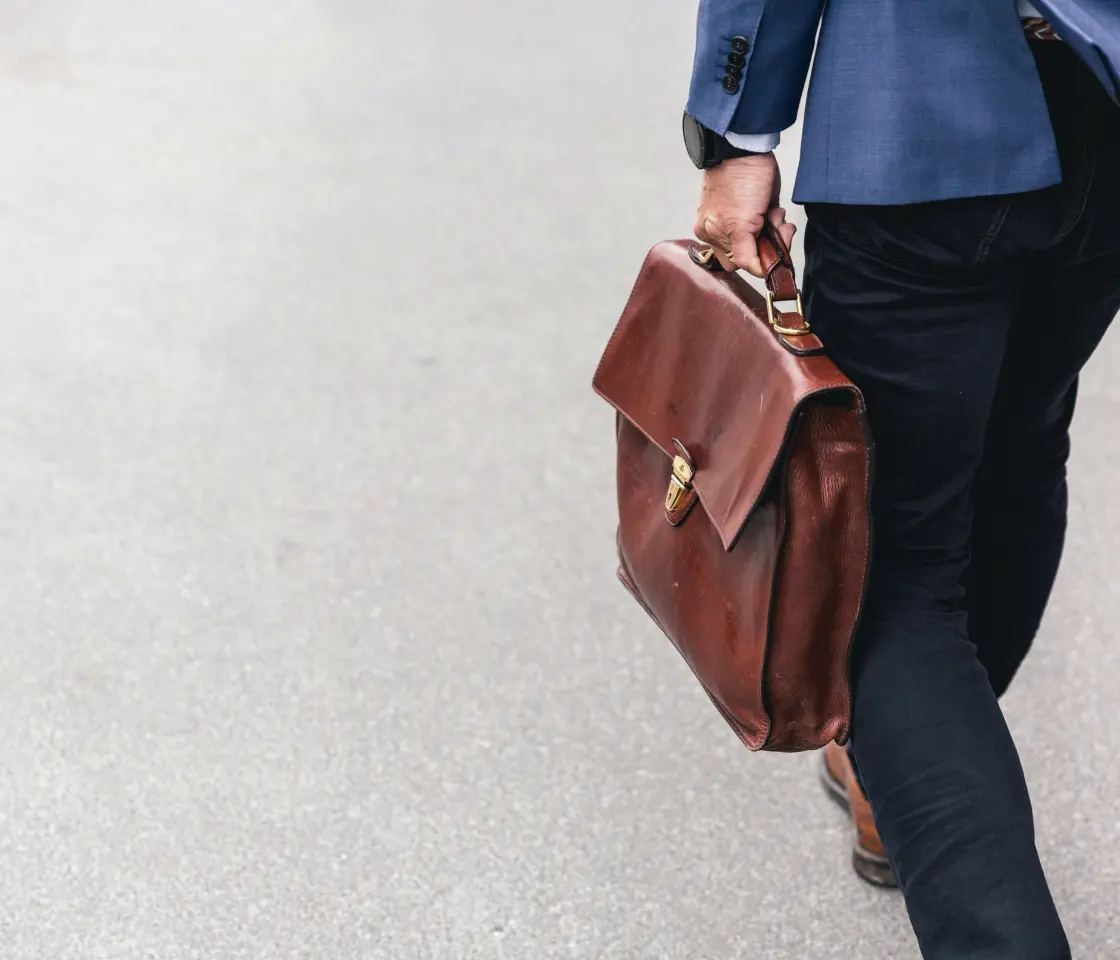 A guy walking with a bag